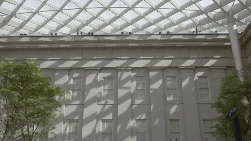 A building facade enclosed by a latticed roof