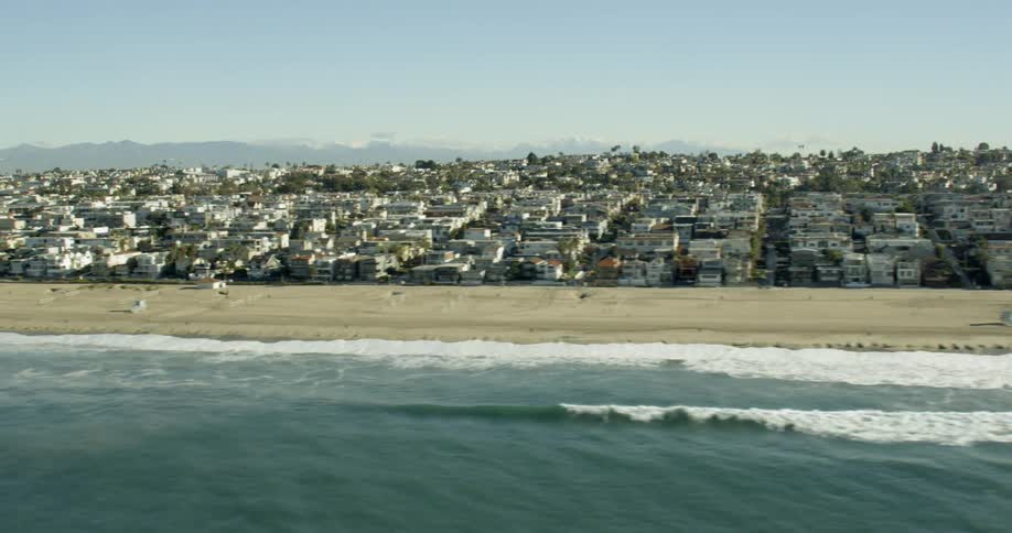 Flying over the ocean looking at a city