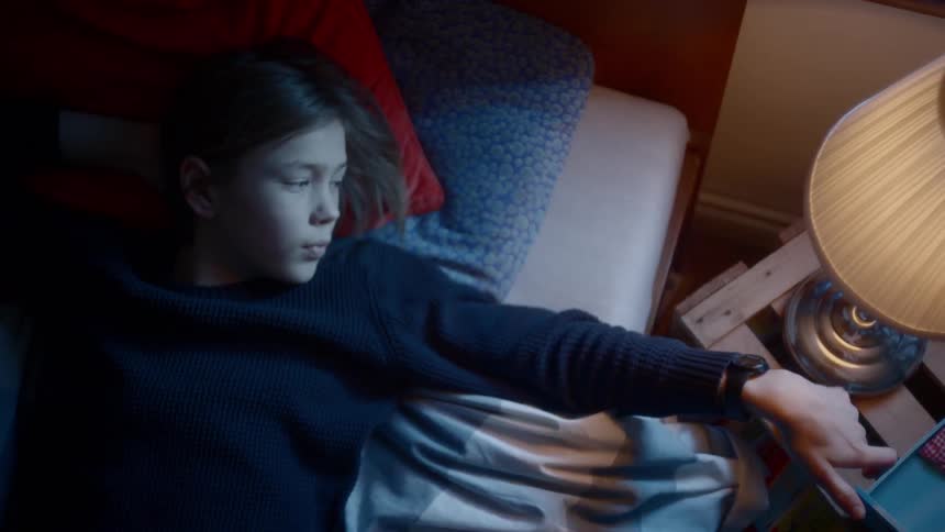 A female turning on lamp in the room