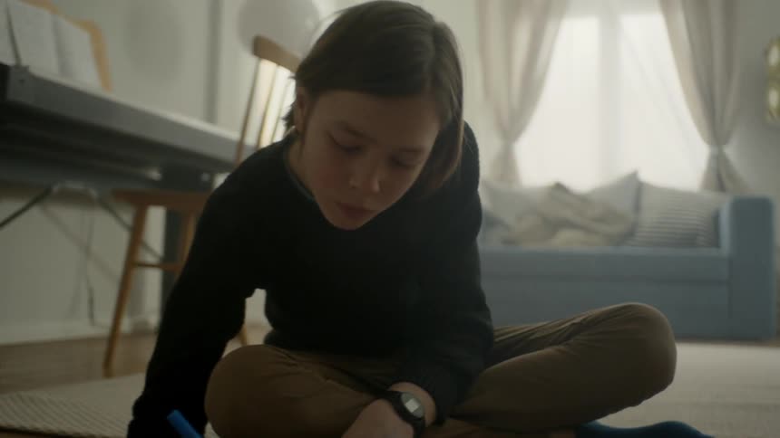 A child is coloring on the floor
