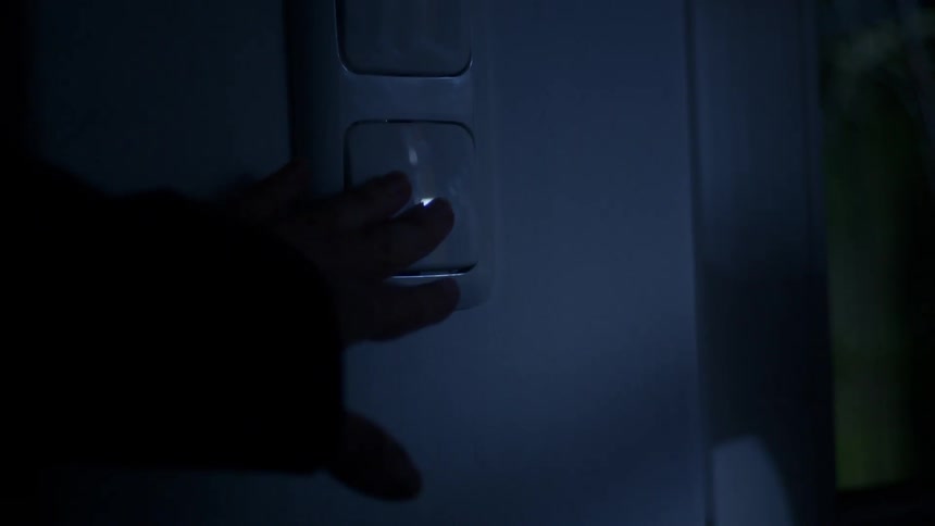 A person touches a switch
