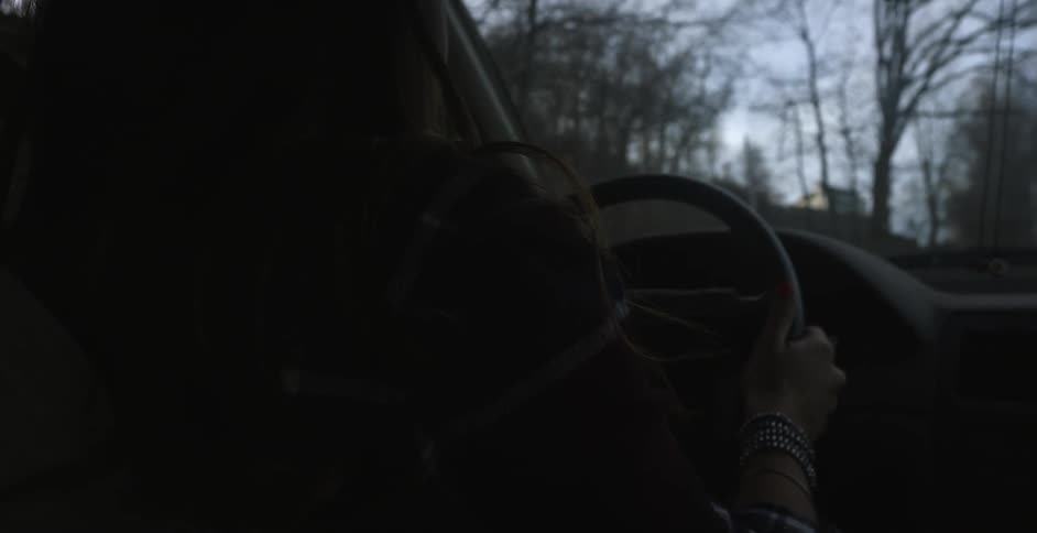 A woman drives a car