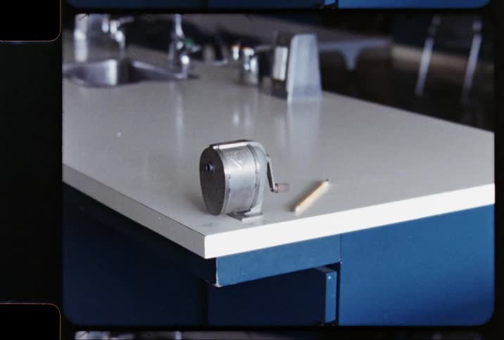 A pencil and sharpener on a counter