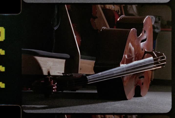 Film footage of a string instrument lying on a floor