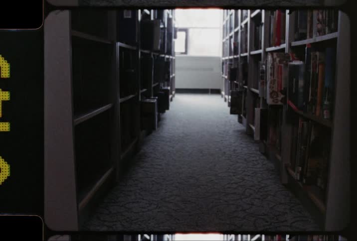 An aisle between bookshelves in a library