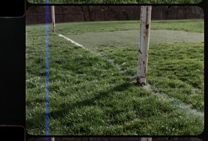 Film footage of a goal post and grass