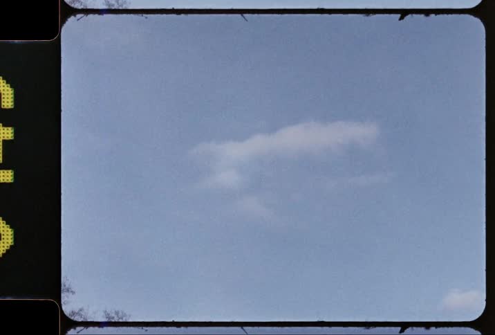 A cloud floats in a blue sky