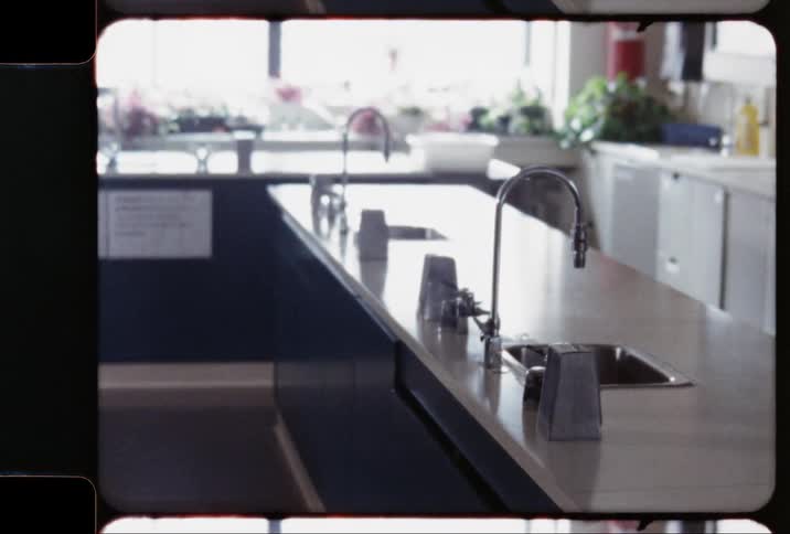 A room has several counters and sinks