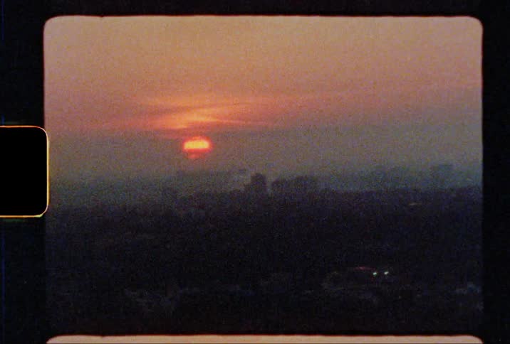 The sun turns orange as it sets over the horizon
