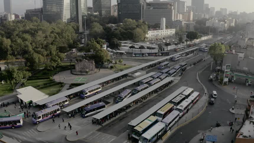 Buses pull in and out of a busy bus station