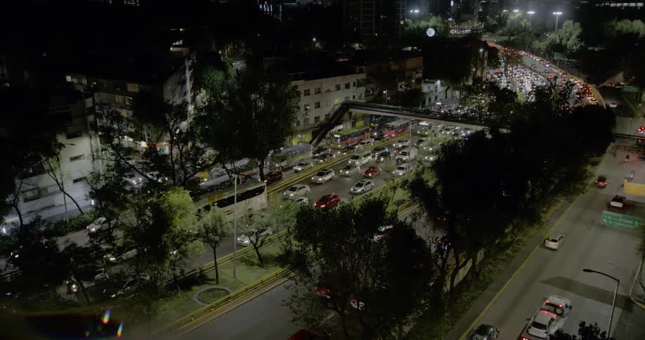 Traffic moves slowly through a large highway in the city