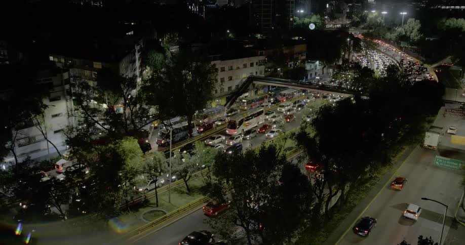 Cars and trucks travel on city highways while others are stuck in traffic at night