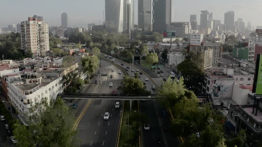 Cars are driving through a downtown city