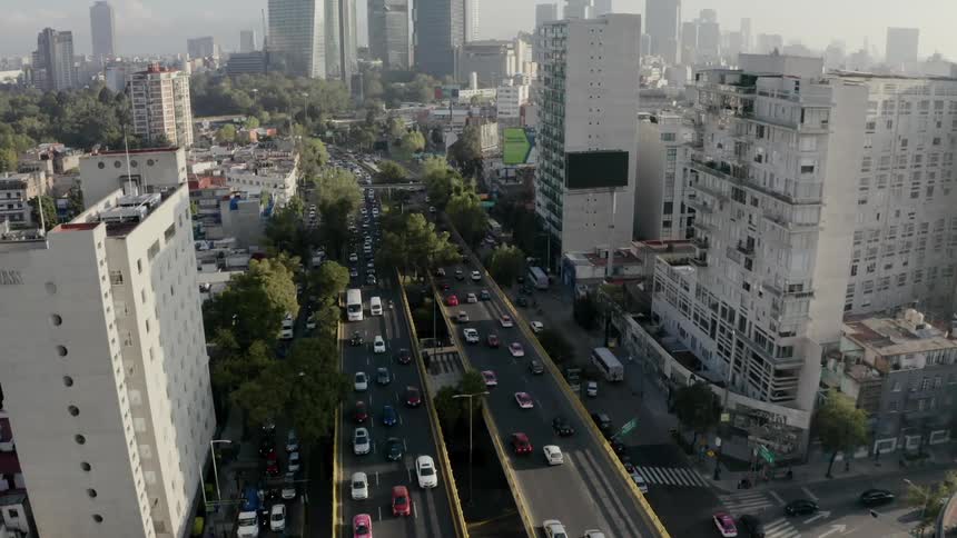 Traffic moves over an elevated freeway in the downtown part of a city