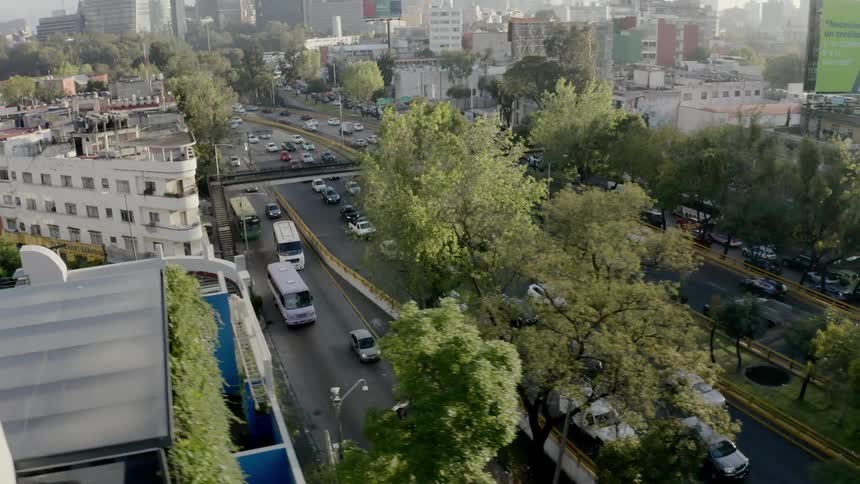 Cars trucks and buses travel on highways in and out of the city
