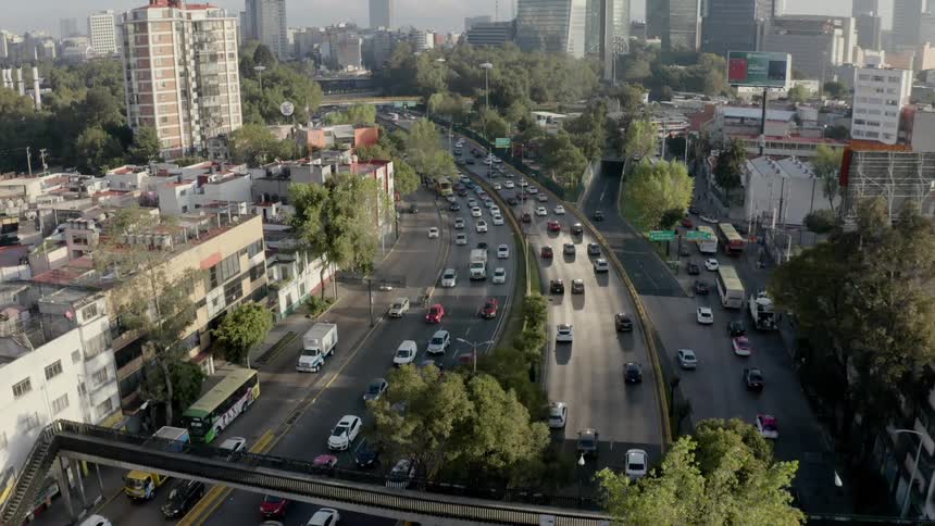 An overpass and busy roads through a city