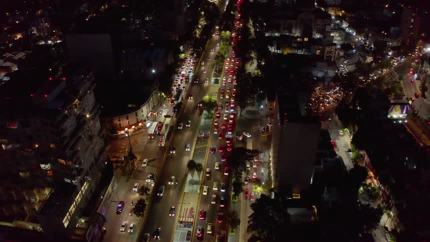Dozens of cars clog up a city street at night