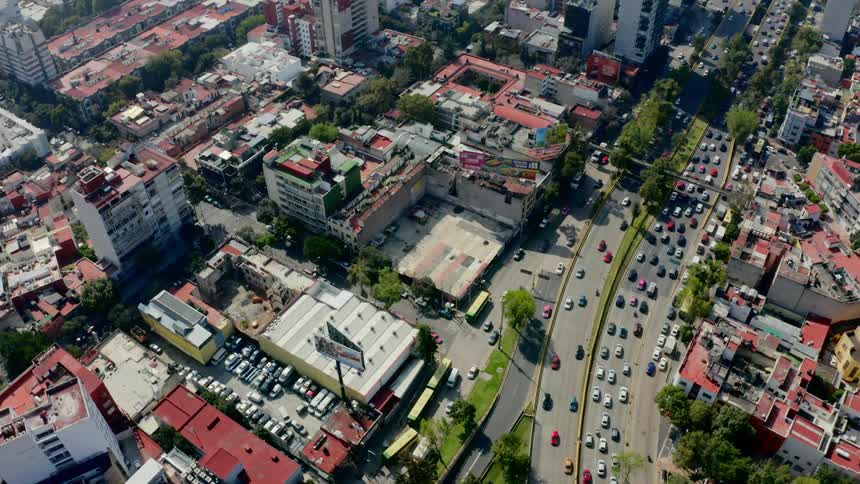 Birds eye view of cars driving down the street in a city