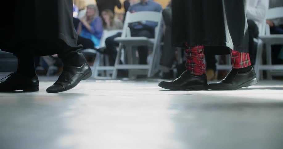 Graduates walk in front of an audience