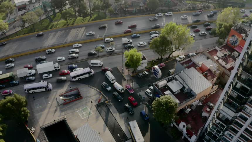 Cars are traveling through a downtown city