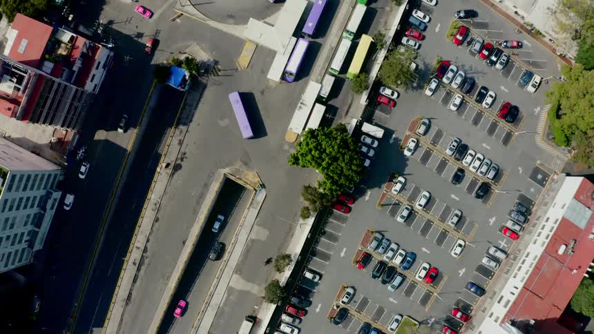 A city with parking lots roads and buses
