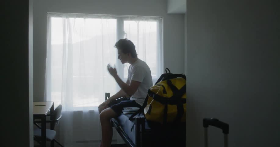 A man removes his hat in bed
