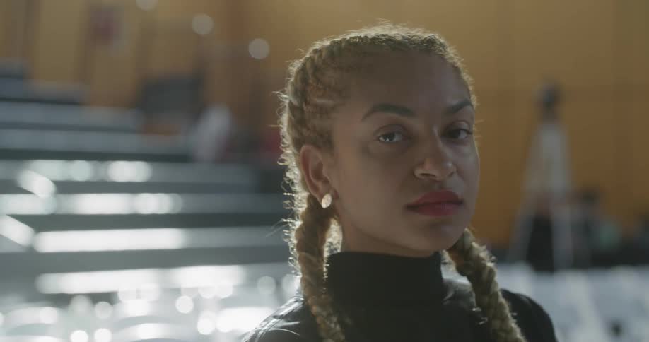 A black woman turns her head and stares