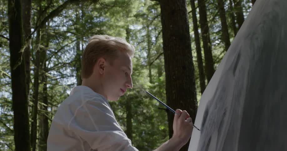 A man paints an animal