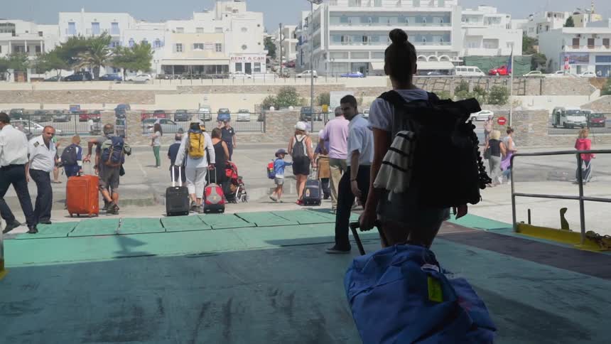 Tourist walking off to travel destination from cruise ship