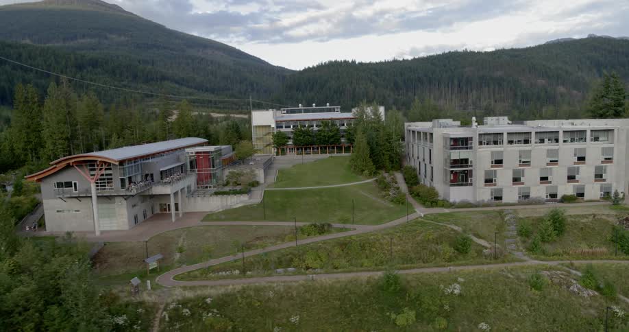 Three large apartment buildings sit atop a hill