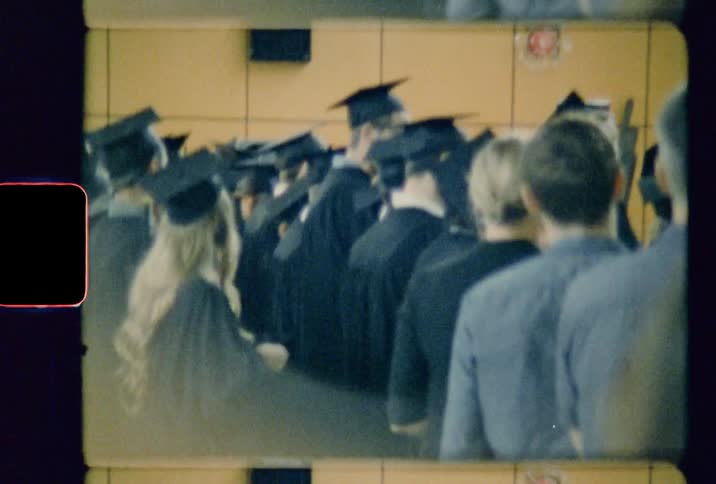 Students at their graduation wearing a black cap and gown