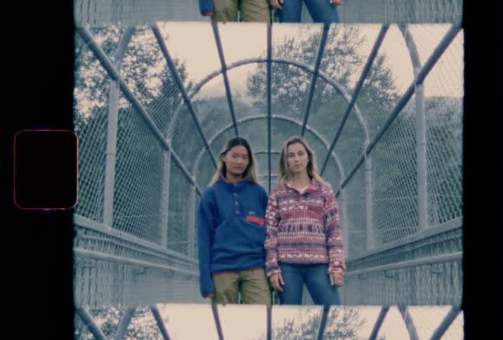Film footage of two girls posing for a camera
