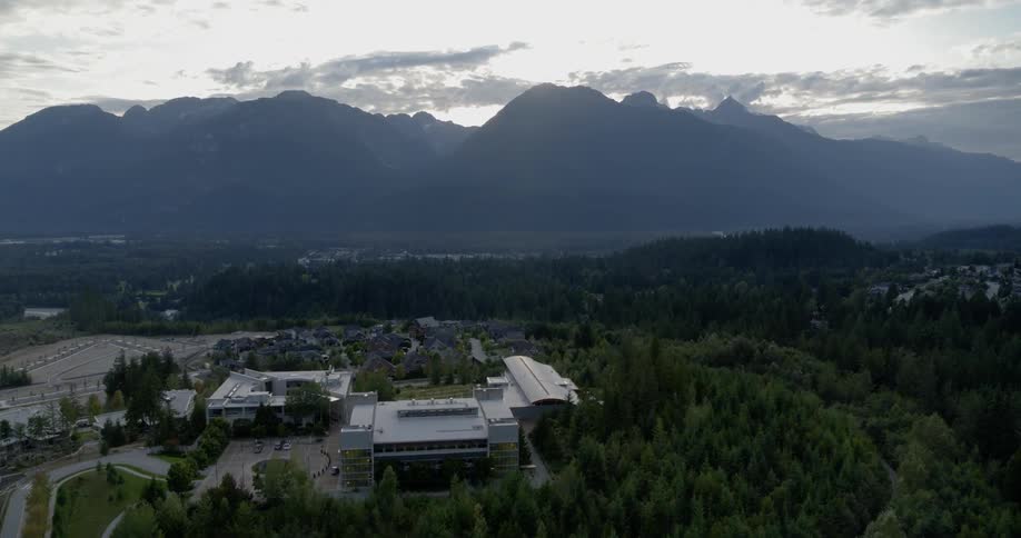A city and its suburbs sit in the shadow of a high mountain range