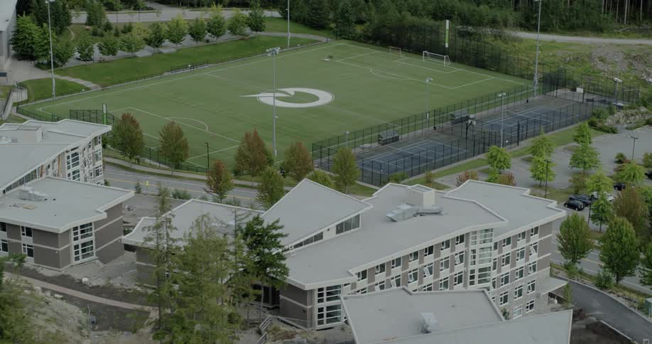 A soccer field sits on the a college campus