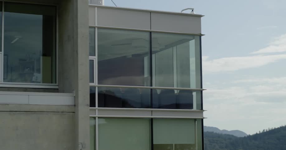An office building in front of a mountain