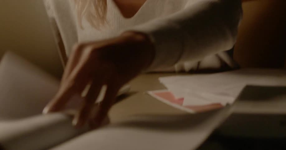 A woman looks through papers on the desk