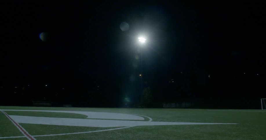 Lights shining on a soccer field at night