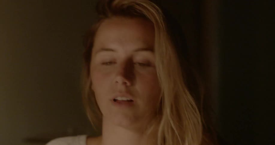 A woman wakes up suddenly from sleeping on the desk