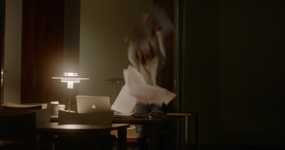 A young girl looks through papers and then throws them everywhere