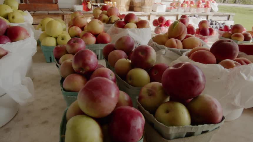Baskets of apples and peaches at a fruit stand