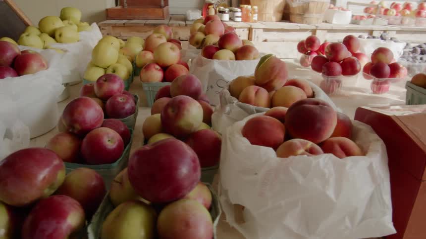 Fresh fruit including apples and peaches in baskets