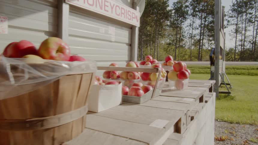 Baskets of apples are displayed on a ledge