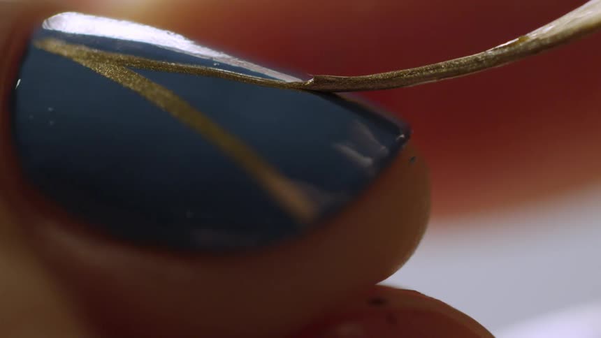 Close up of a person painting a nail