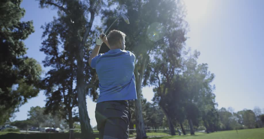 Golfer takes a swing and follows ball with his eyes