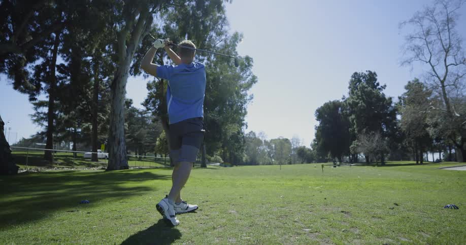 Man tees off as truck drives past golf course