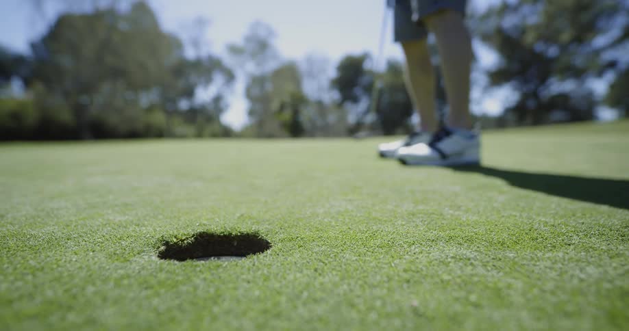 A man plays golf