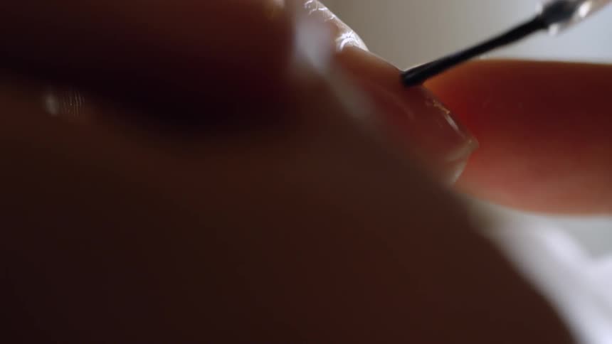 A fingernail is painted