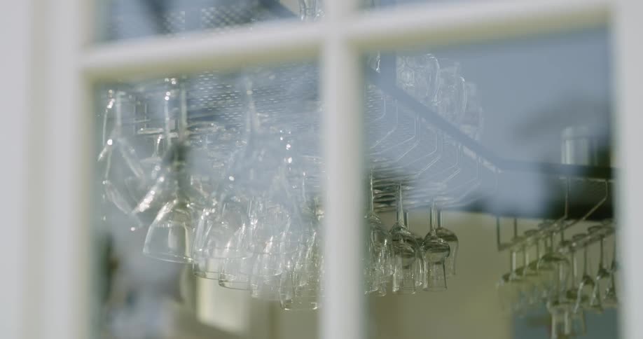 The glasses are hanging in the kitchen