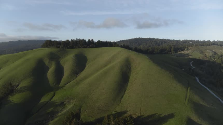 Aerial of grassy rolling hills in the country
