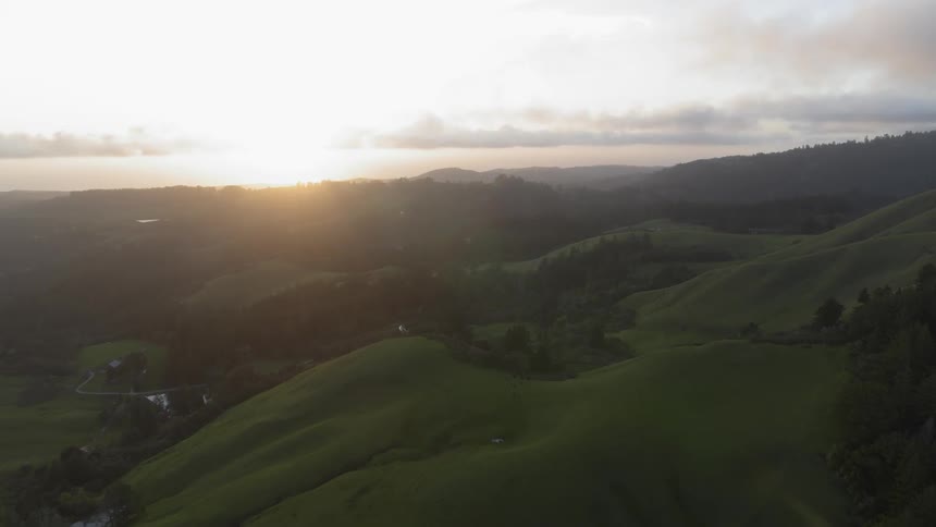 Landscape of green hills at sunset